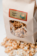 Bag of caramel popcorn with a visible brand label on a white background