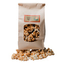 Bag of caramel popcorn with a clear window showing the popcorn inside, on a white background.