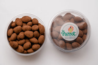 Container of brown candy with 'The Parrot' label on a white background