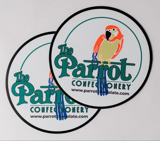Two round stickers with 'The Parrot Confectionery' logo on a white background