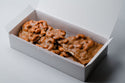 Box of peanut brittle on a white background