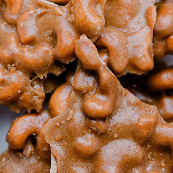 Close-up of maple cashew brittle with a glossy texture
