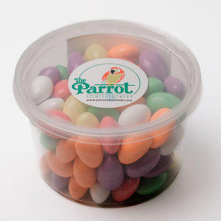 Container of colorful candy with 'The Parrot' logo on a white background