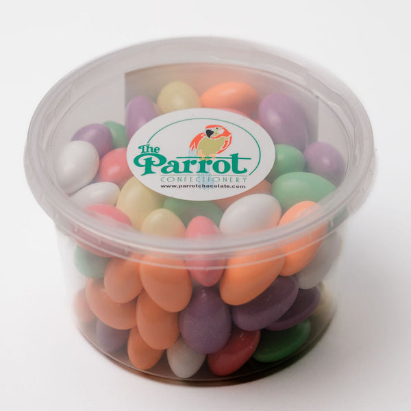 Container of colorful candy with 'The Parrot' logo on a white background
