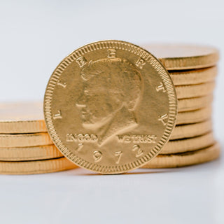 Gold chocolate coins with a prominent coin showing 'Liberty' on a white background