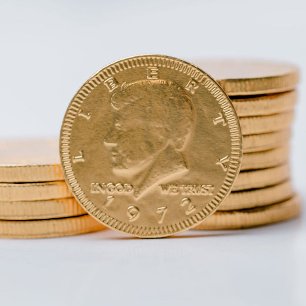 Gold chocolate coins with a prominent coin showing 'Liberty' on a white background