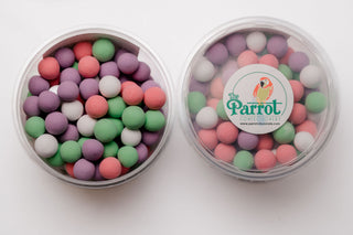 Clear container with pastel-colored candies and 'The Parrot Confectionery' logo on a white background