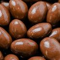 Close-up of chocolate-covered almonds with a glossy finish.