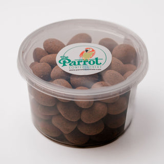 Container of brown candy with 'The Parrot' label on a white background