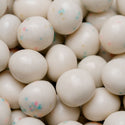 Close-up of white candy balls with colorful specks, likely used as a play item or toy.