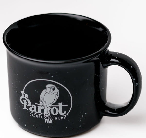 Black mug with 'The Parrot Confectionery' logo on a white background