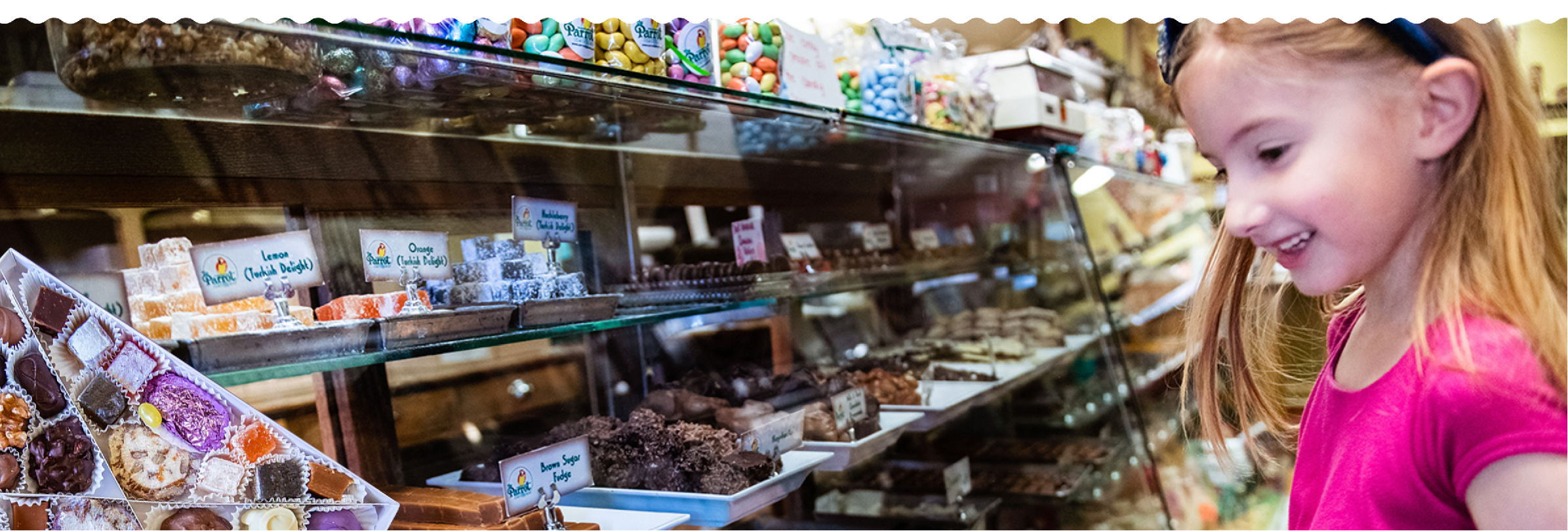 Young girl in a grocery store looking at food items on a shelf